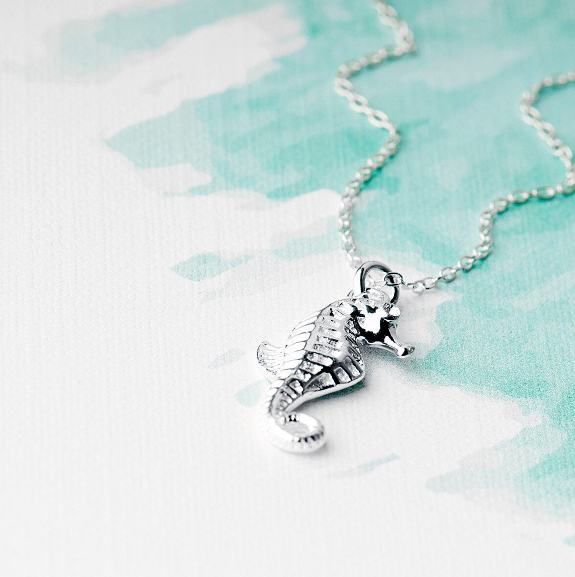 Seahorse sterling silver necklace with intricate detailing and a sparkling CZ eye