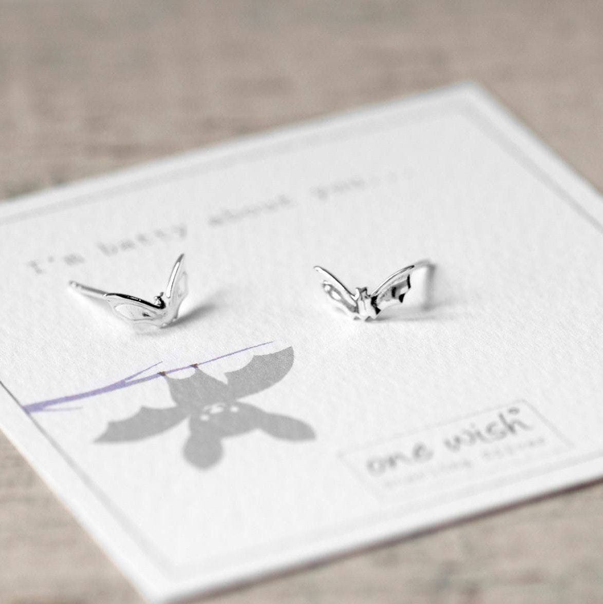 Uber cute little Flying bats stud earrings made from Sterling Silver beautifully packaged on our bespoke One Wish gift card which reads 'I'm batty about you'