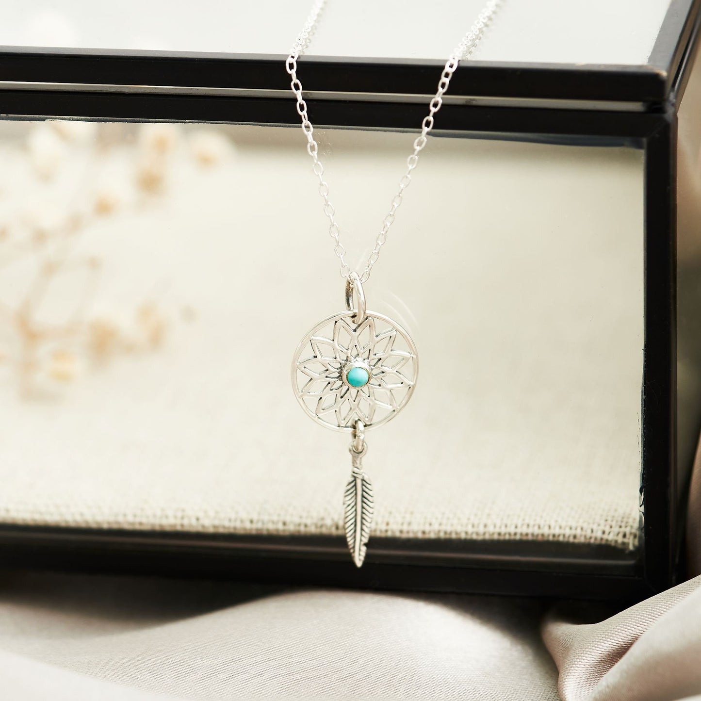 Dream catcher sterling silver necklace with turquoise stone at the centre and dangling silver feather motif,  on bespoke gift card that says  - May all your dreams come true