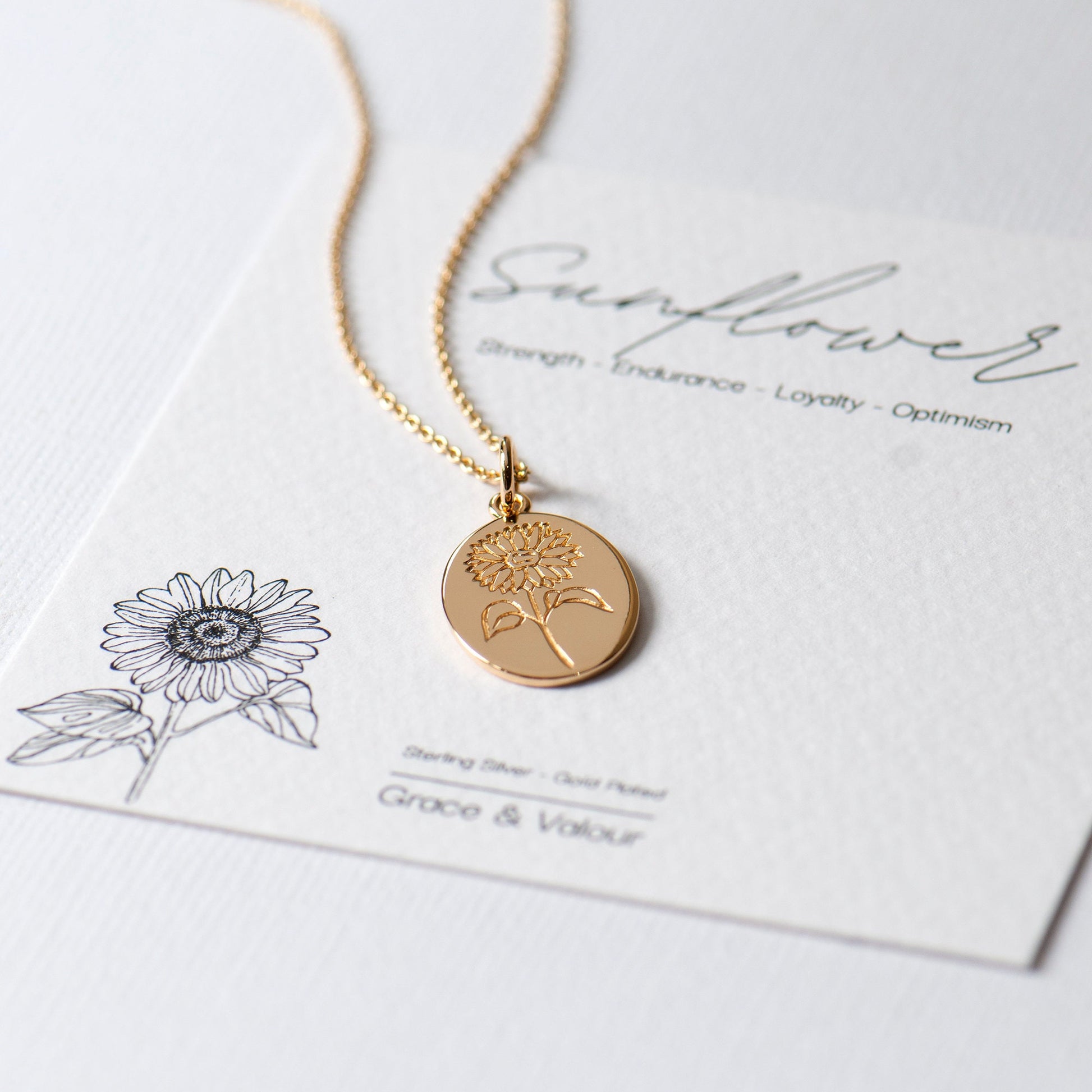 sunflower gift card with a gold engraved oval sunflower pendant on a dainty 17.5 inch gold chain. Made from Sterling silver and gold plated.
