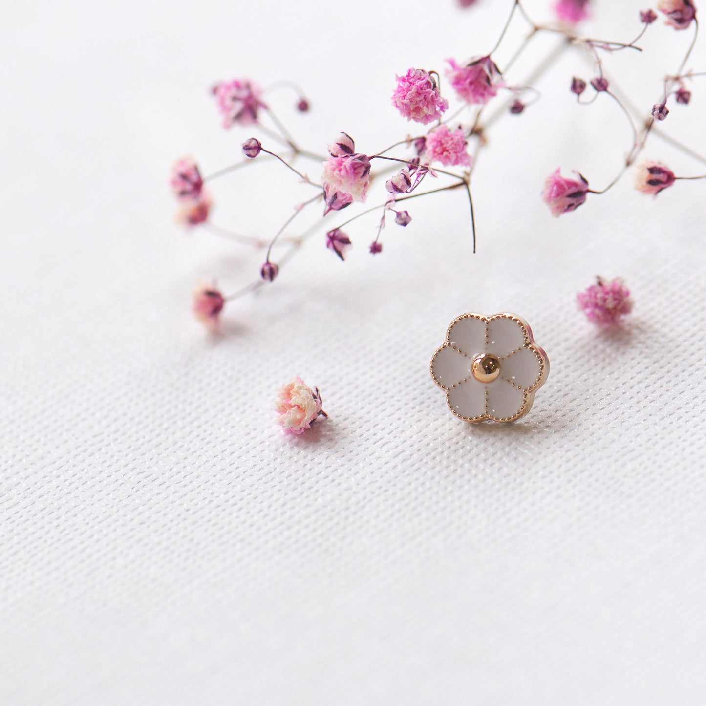 Tiny cute little white enamel flower modesty pin close up picture