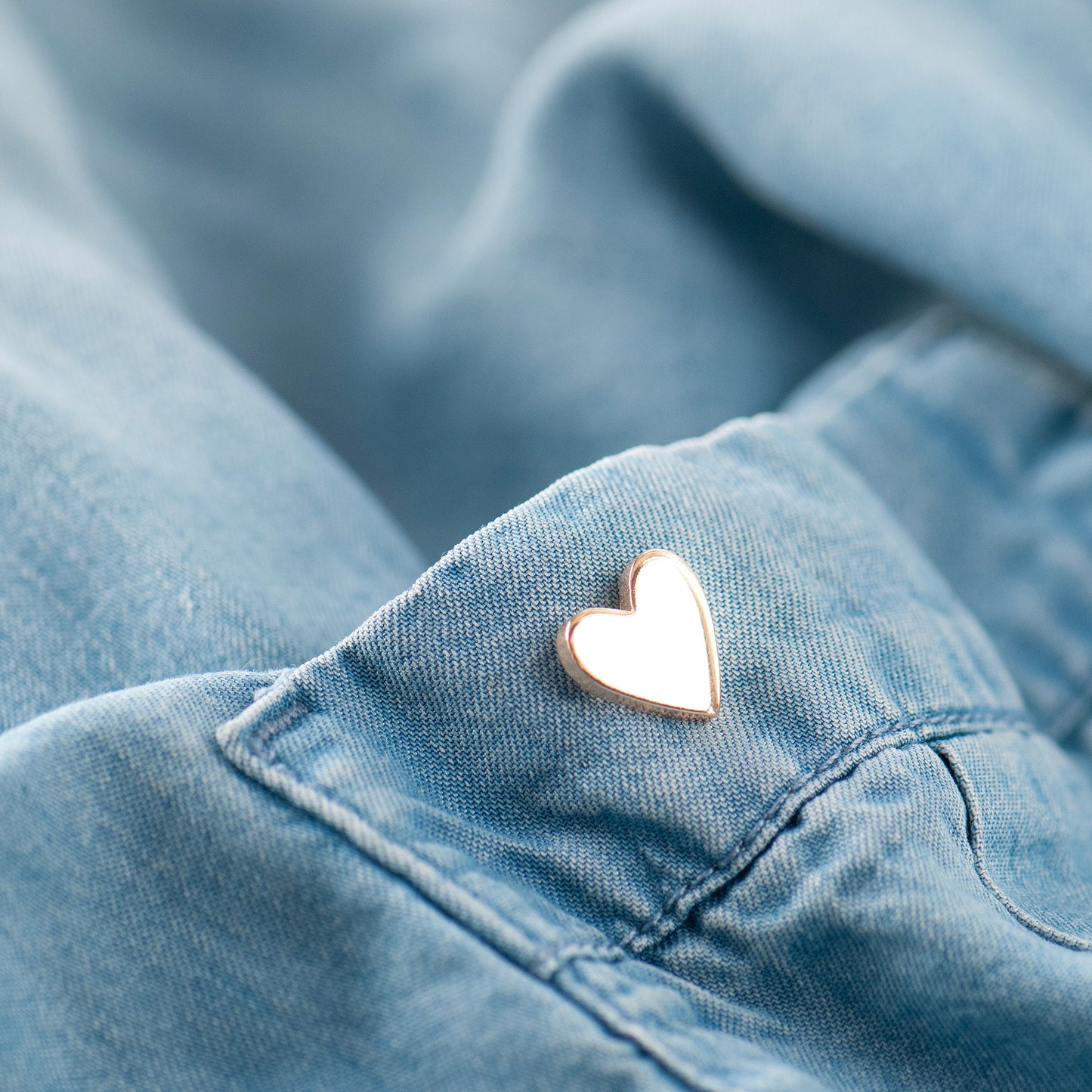 Heart-shaped pin on a denim pocket