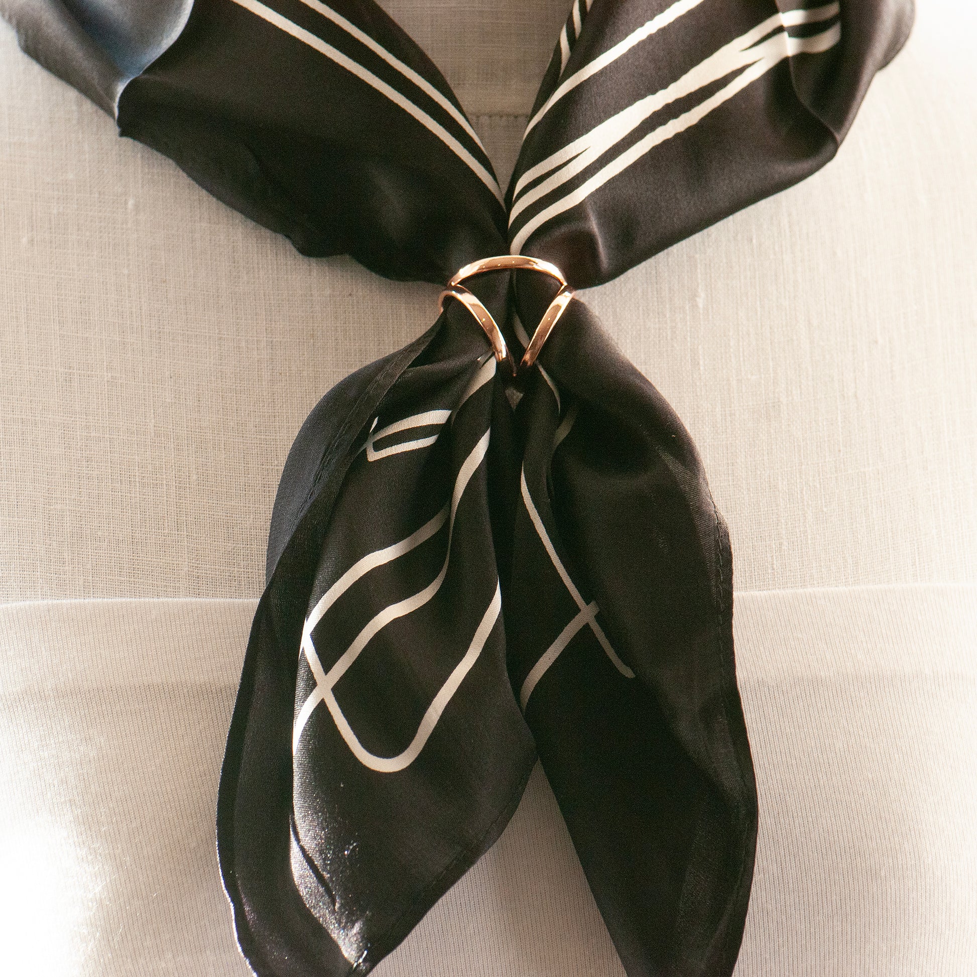 three way metal scarf ring on a tied scarf