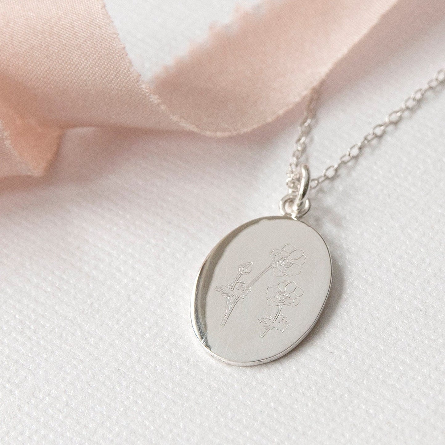 close up of engraved wildflowers necklace in sterling silver