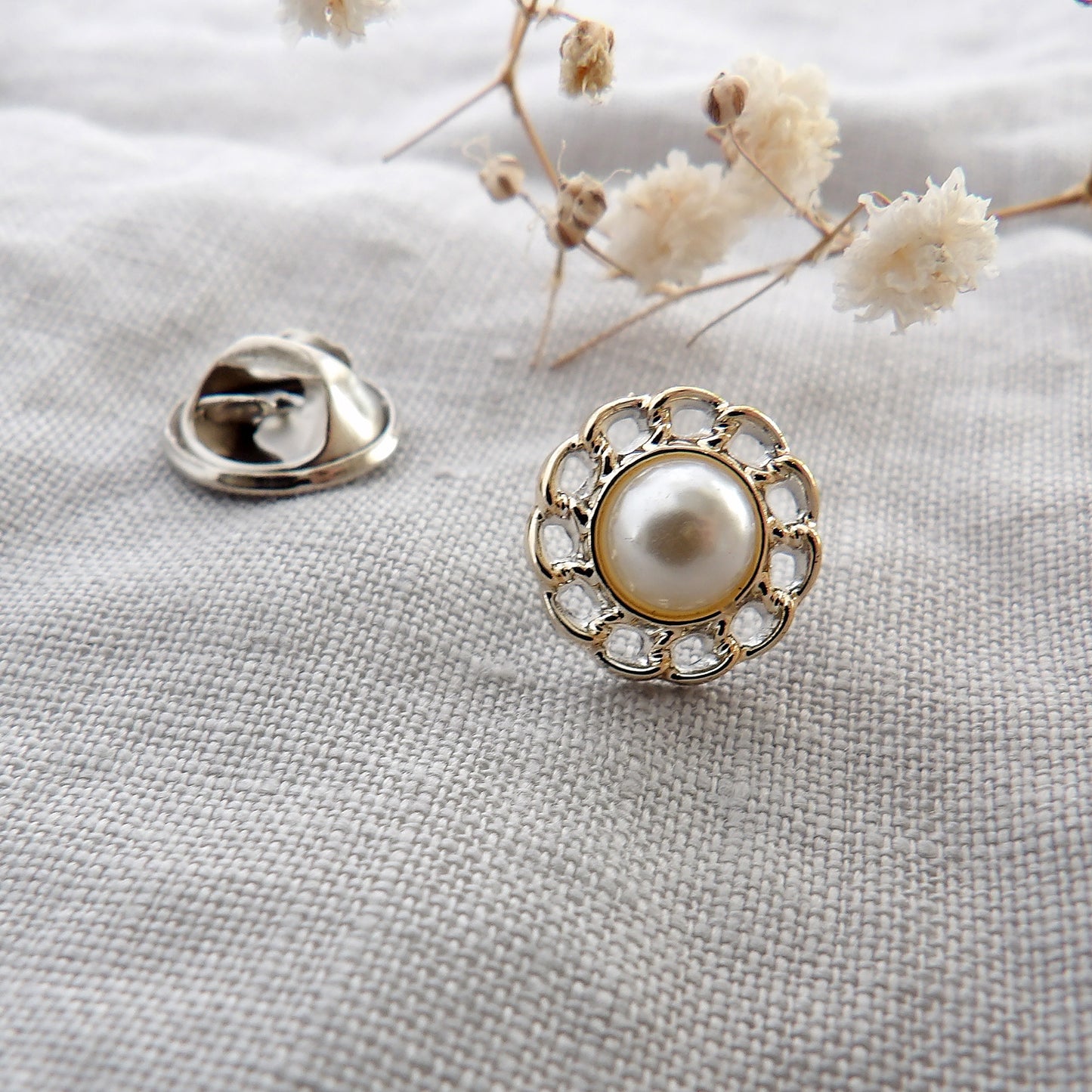 close up detail of flower pearl modesty pin