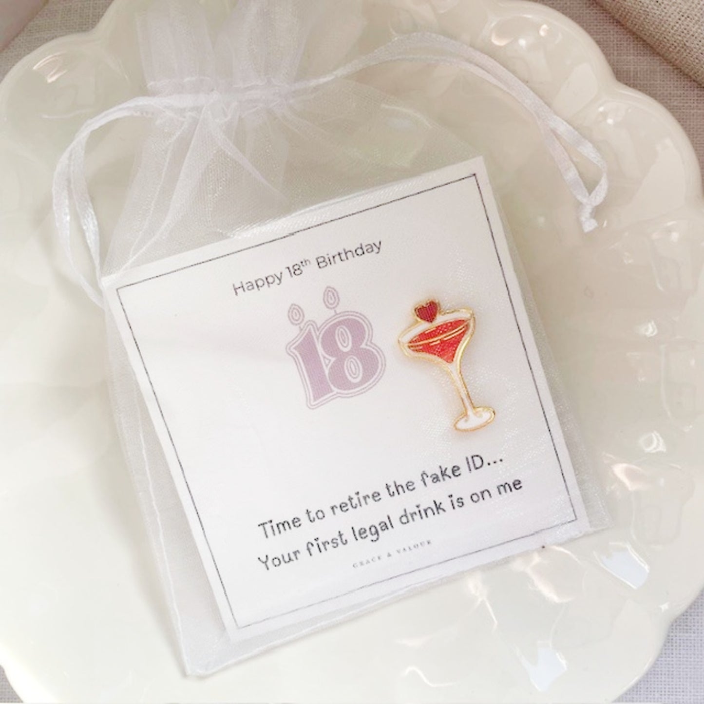 18th birthday gift with cocktail-themed pin and card on a white background