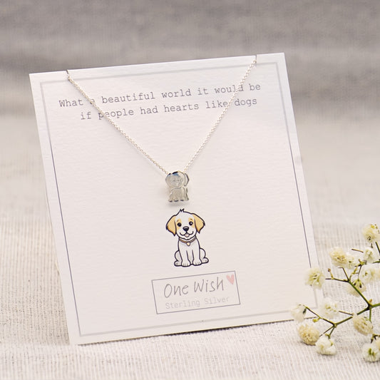 A sterling silver necklace with a small dog pendant displayed on a white gift card. The card features a cute illustration of the dog and the text 'One Wish Sterling Silver'.