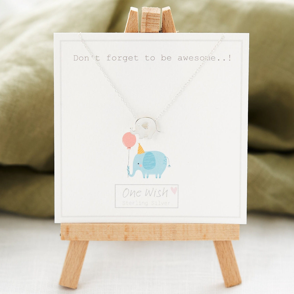A sterling silver elephant necklace displayed on a card with a message that reads 'Don't Forget to be AWESOME today.
