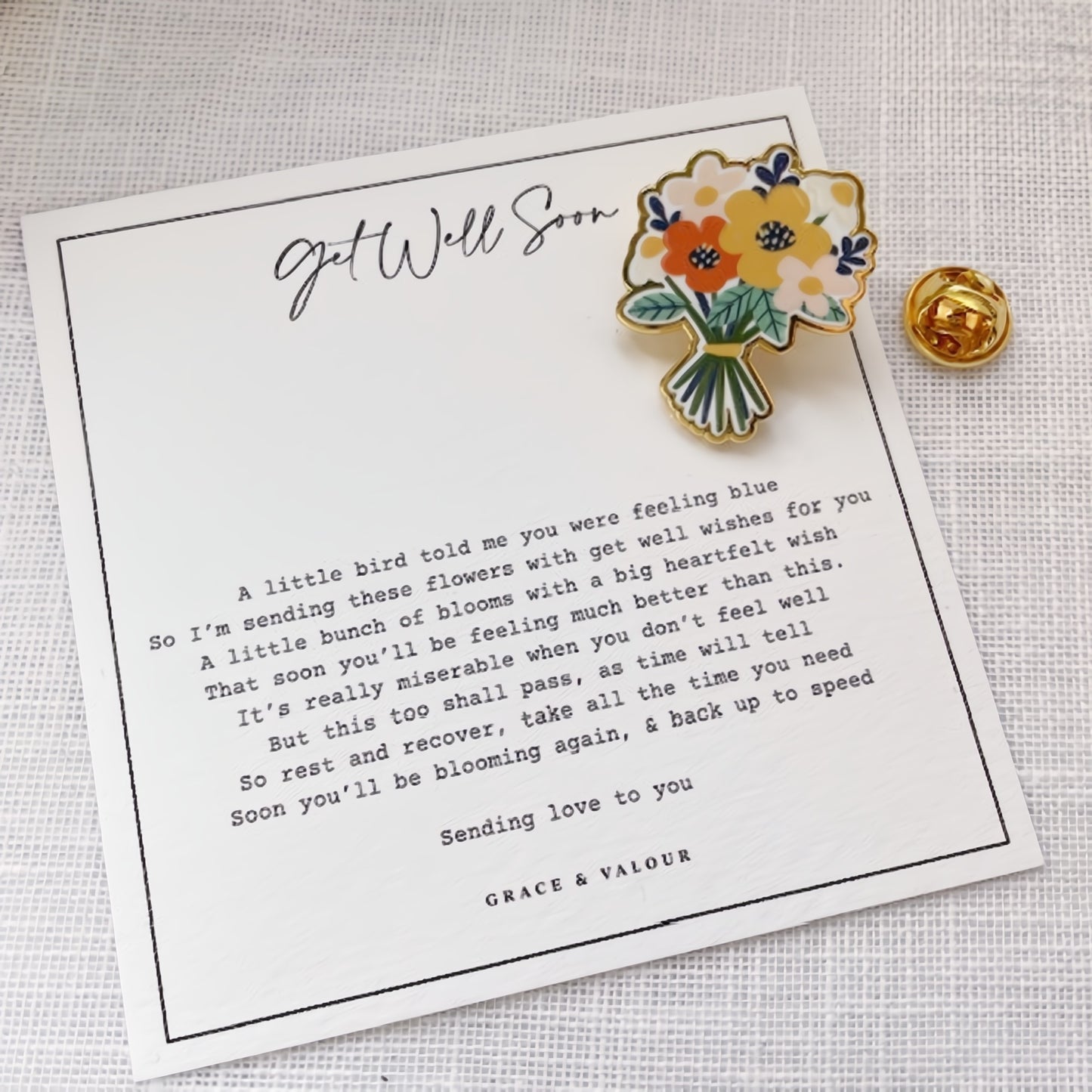 Floral-themed pin on a 'Get Well Soon' card with a message.