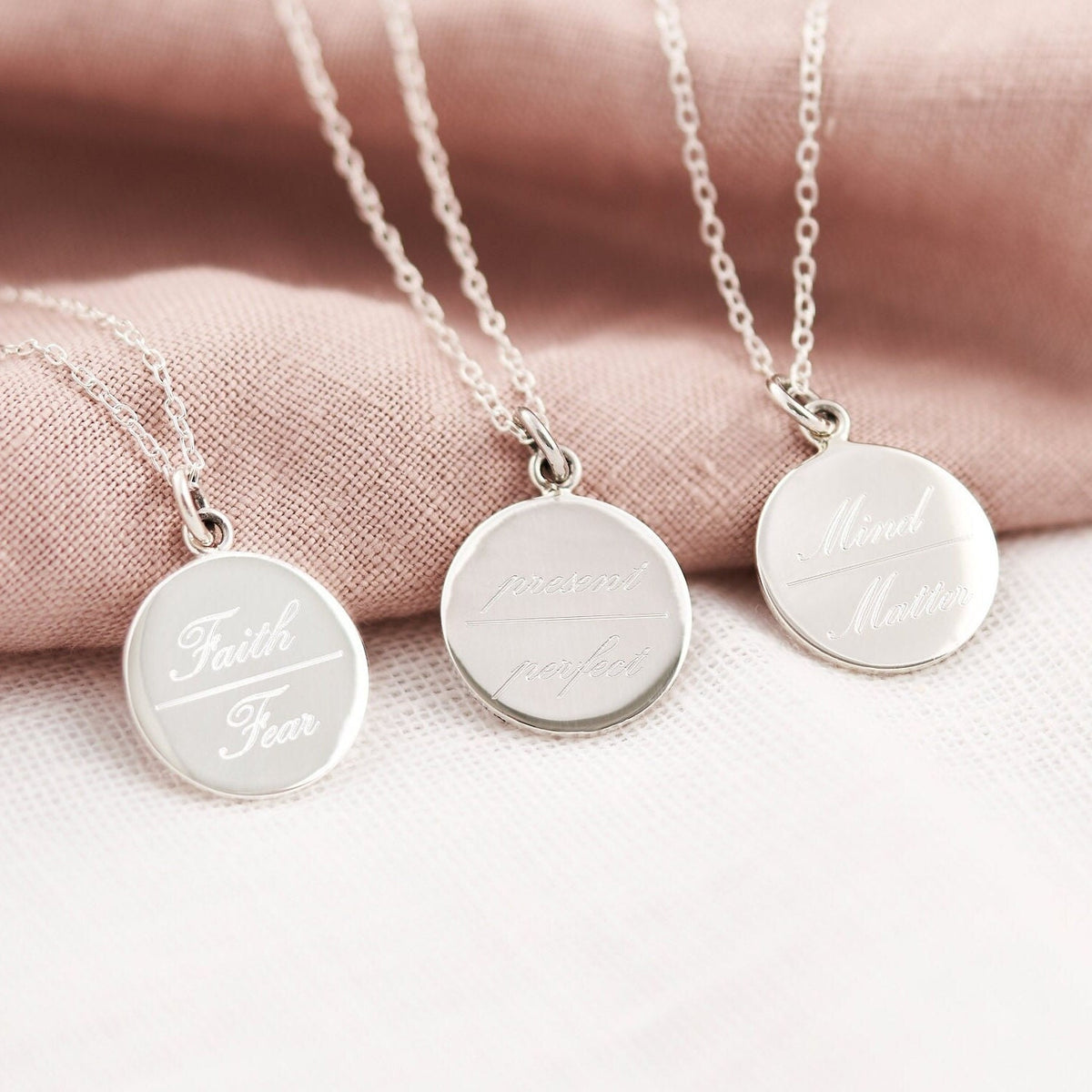 3 necklaces engraved with faith over fear, present over perfect and mind over matter