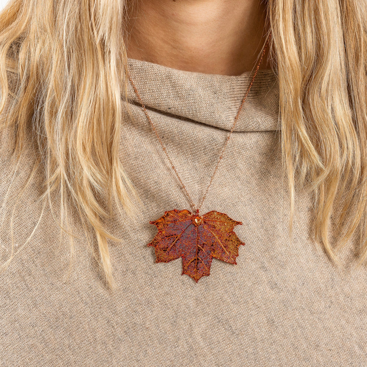 irridescent maple leaf necklace worn by model