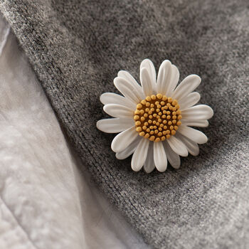 White daisy brooch on lapel