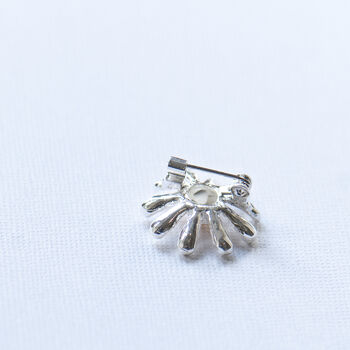 Tiny silver and gold daisy brooch back view showing the pin