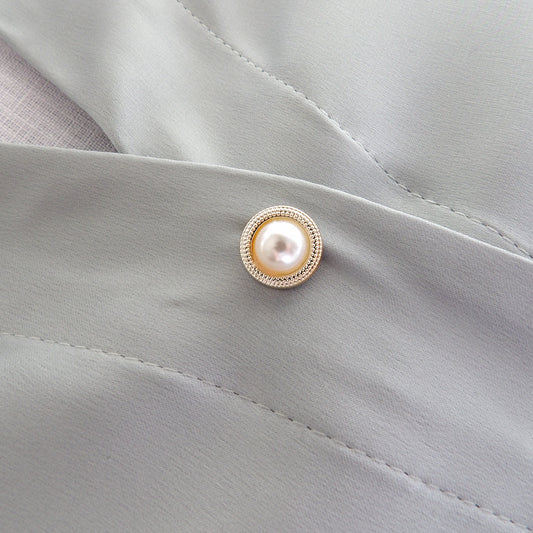 pearl and gold surround modesty pin on low cut blouse, extra button pin
