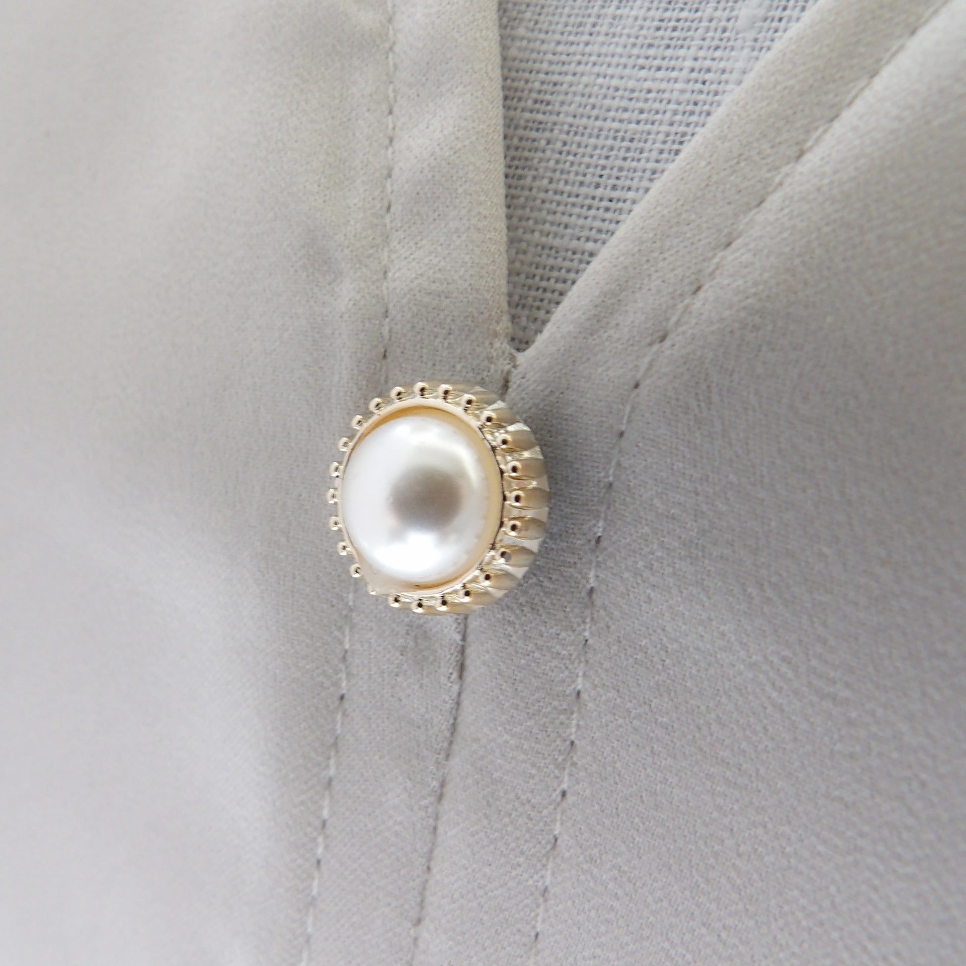 pearl modesty pin on low cut top as an extra button