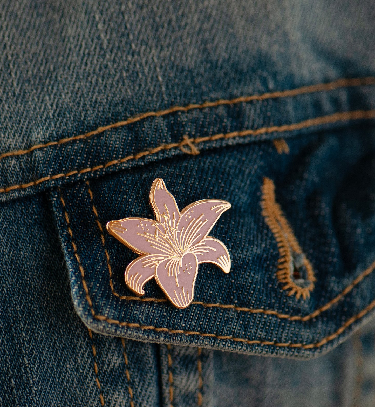 pink and gold stargazer lily on jacket pocket showing all the pretty gold detailing