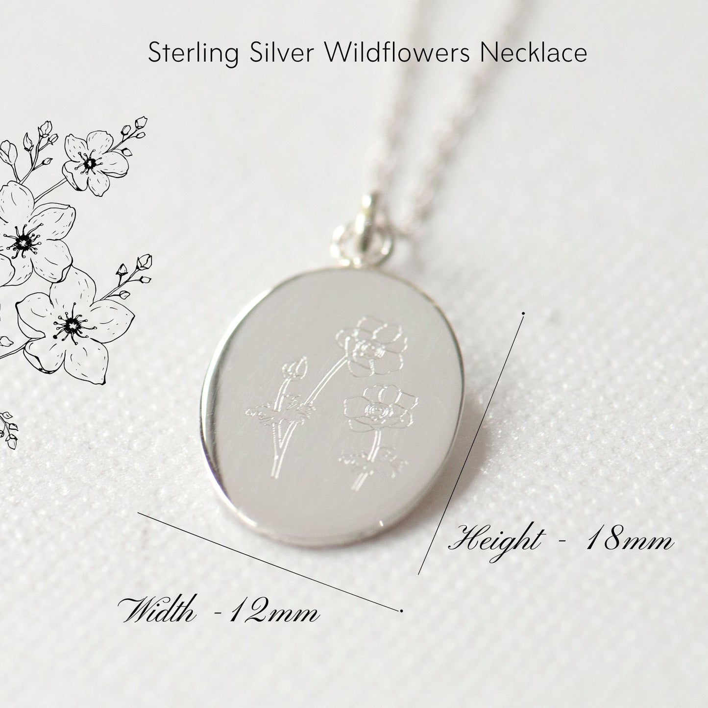 A sterling silver wildflowers necklace with an oval flower pendant, featuring line art of flowers on the pendant and a measurement diagram showing the necklace length and width.