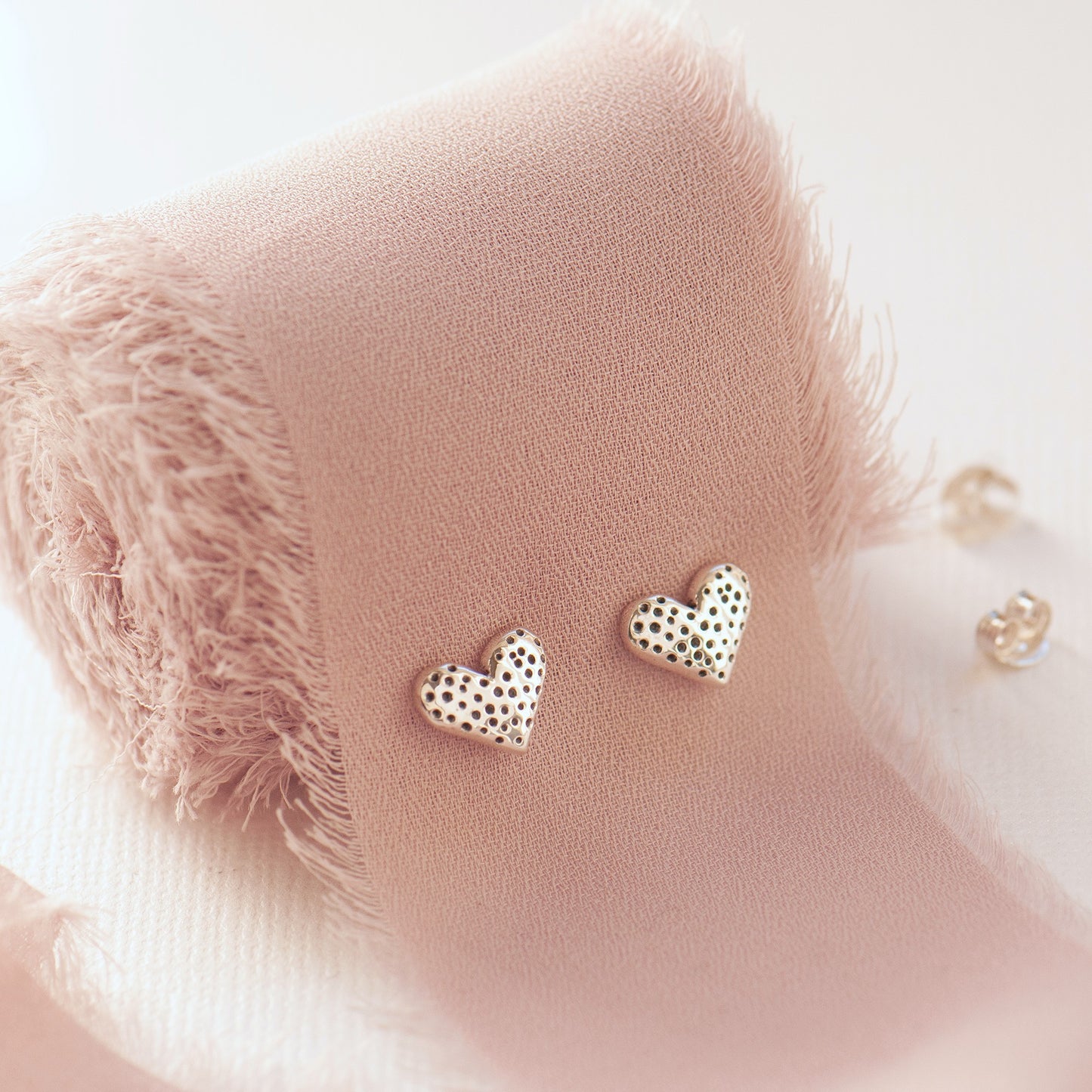 Sweet little pair of sterling silver textured heart stud earrings