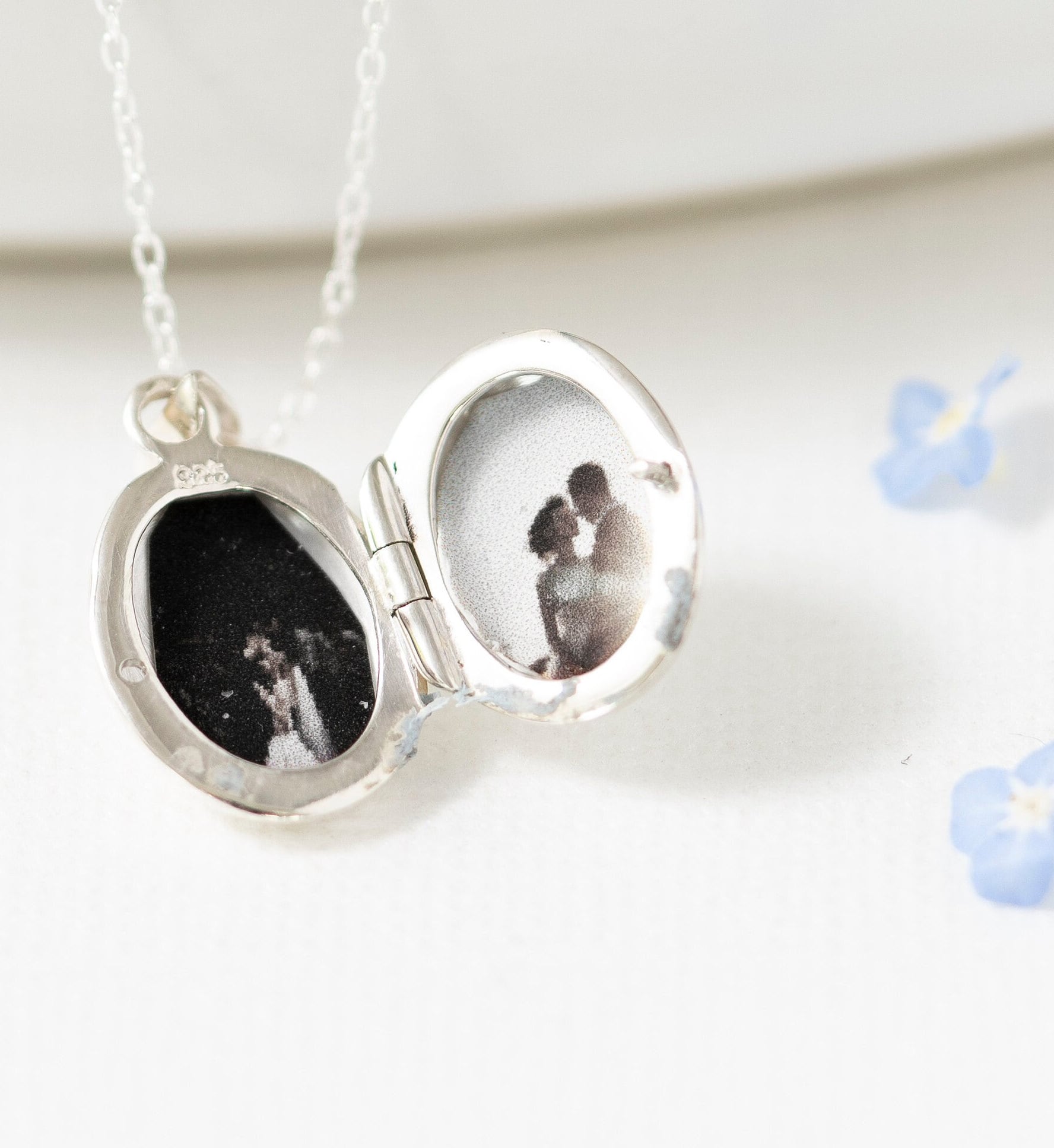 inside picture of the tiny locket necklace showing two little pictures