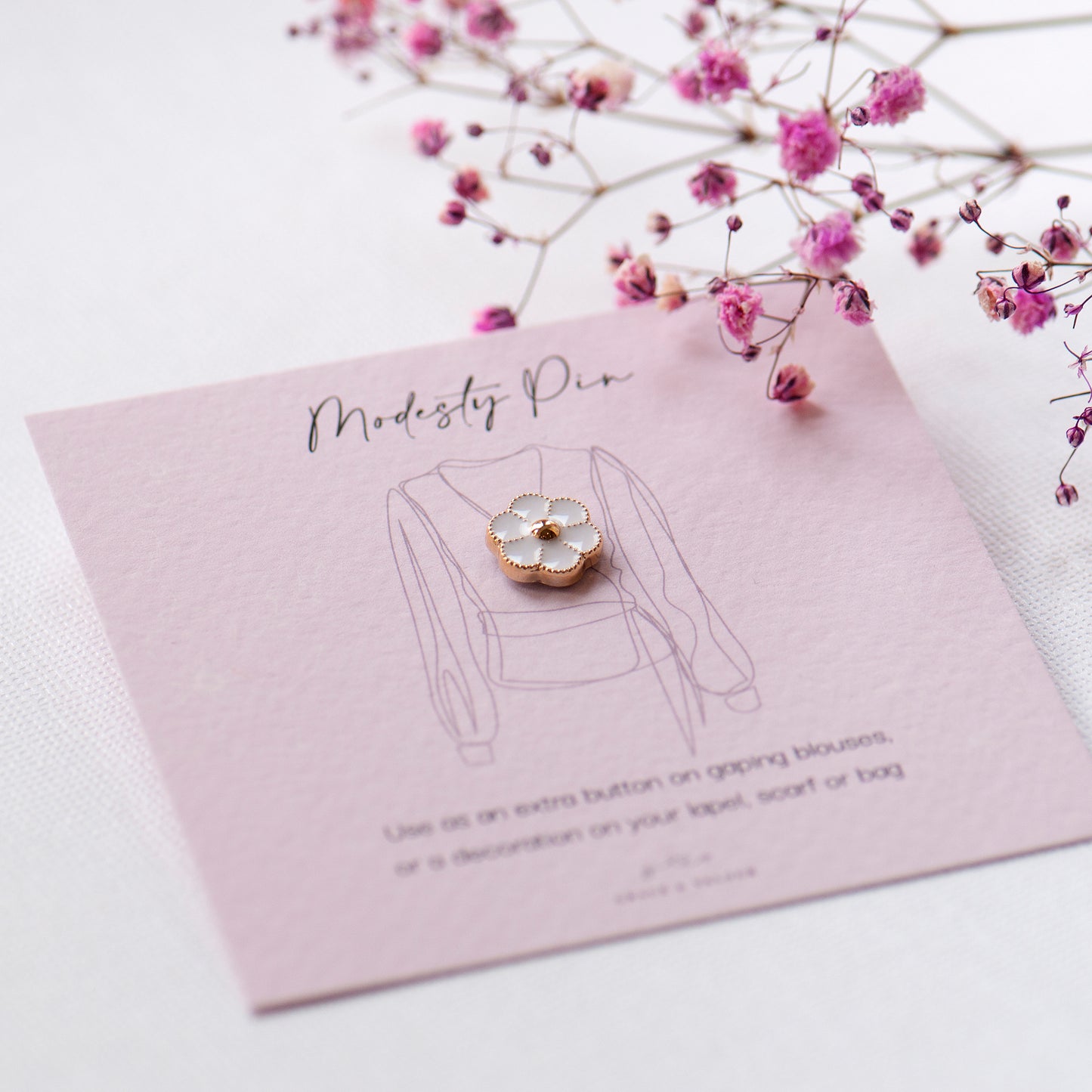 white flower small enamel pin on modesty pin gift card ready for gifting