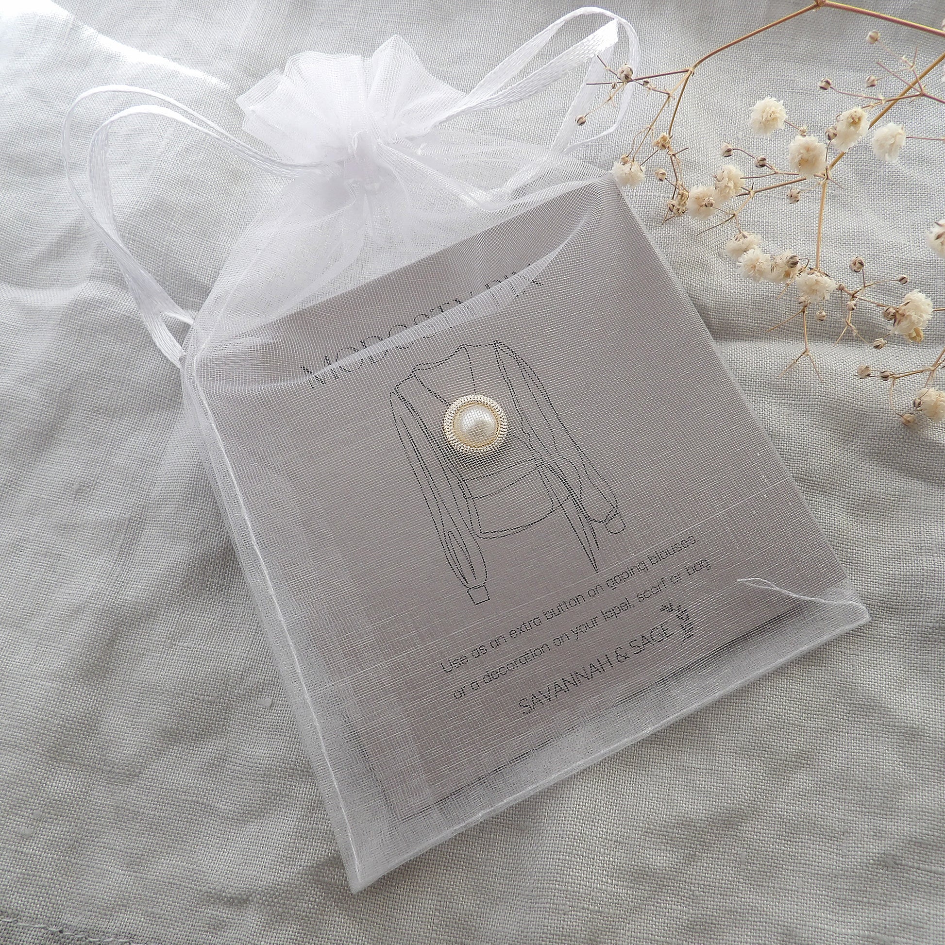 white pearl modesty pin on giftcard in chiffon pouch for gifting
