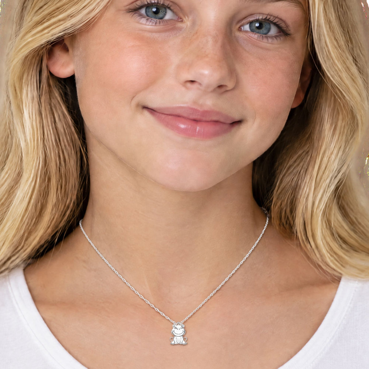 young blonde girl wearing a frog pendant