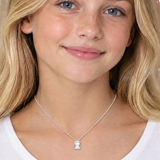 young blonde girl wearing a frog pendant